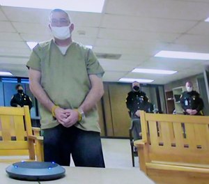Former Columbus police officer Adam Coy is seen remotely on television during his initial appearance on Friday, Feb. 5, 2021, at the Franklin County Common Pleas Courthouse in Columbus, Ohio.