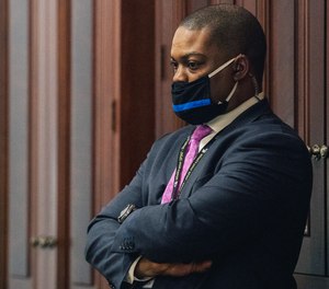 U.S. Capitol Police officer Eugene Goodman watches never-before-seen security footage of rioters storming the Capitol on Jan. 6 on Wednesday, Feb. 10, 2021 in the Capitol in Washington.