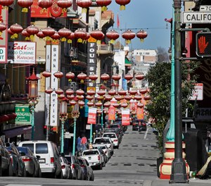 n this Jan. 31, 2020, file photo, a masked worker cleans a street in the Chinatown district in San Francisco.