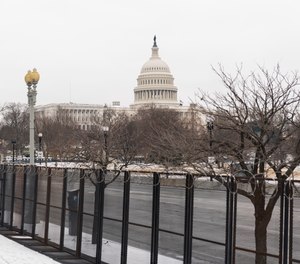 The U.S. Capitol is seen behind the metal security fencing around the U.S. Capitol, Thursday, Feb. 18, 2021.