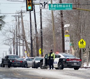 A Dallas police presence is seen at the street intersection of Belmont and Henderson in a neighborhood where earlier in the day two other officers were shot responding to an emergency call in Dallas, Thursday, Feb. 18, 2021.