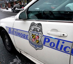 A Baltimore police cruiser is seen parked, Thursday, Feb. 18, 2021, in Baltimore.