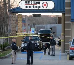 Jefferson Parish Sheriff's Office and Bureau of Alcohol, Tobacco, Firearms and Explosives: ATF investigators look at evidence at the scene of a multiple fatality shooting at the Jefferson Gun Outlet in Metairie, La.
