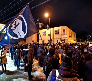 A crowd gathers near the site of Daniel Prude's encounter with police officers in 2020, in Rochester, N.Y., Tuesday, Feb. 23, 2021.