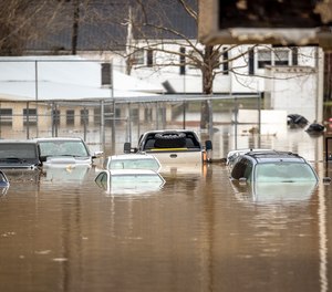 Floodwaters cover a parking lot in Paintsville, Ky. on Monday, March 1, 2021, following severe thunderstorms. First responders performed numerous water rescues and a state of emergency was declared in Kentucky due to the flooding.