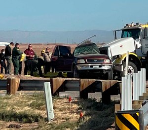 In this image from KYMA law enforcement work at the scene of a deadly crash involving a semitruck and an SUV in Holtville, Calif., on Tuesday, March 2, 2021.