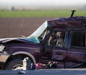 A California Highway Patrol officer examines the scene of a deadly crash in Holtville, Calif., Tuesday, March 2, 2021.