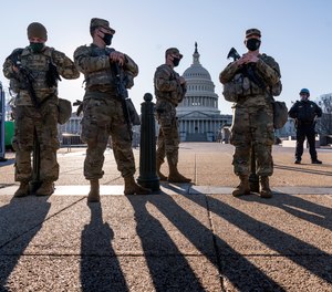 Members of the Michigan National Guard and the U.S. Capitol Police keep watch as heightened security remains in effect around the Capitol grounds since the Jan. 6 attacks by a mob of supporters of then-President Donald Trump, in Washington, Wednesday, March 3, 2021.