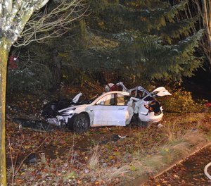 This Nov. 17, 2020, file photo shows where an Oregon man crashed a Tesla while going about 100 mph, destroying the vehicle, a power pole and starting a fire when some of the hundreds of batteries from the vehicle broke windows and landed in residences in Corvallis, Ore.