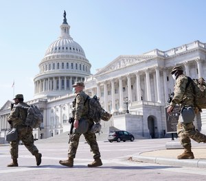 National Guard walk near the Capitol, Thursday, March 4, 2021, on Capitol Hill in Washington.