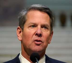 In this Dec. 8, 2020, file photo, Georgia Gov. Brian Kemp speaks to reporters in the Capitol in Atlanta.