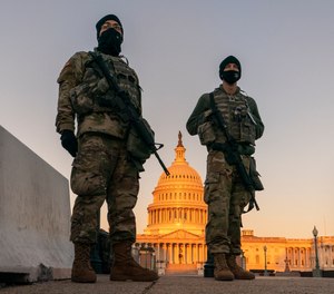 National Guard stand their posts around the Capitol at sunrise in Washington, Monday, March 8, 2021.