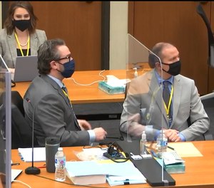 In this image from video, defense attorney Eric Nelson left, and defendant, former Minneapolis police officer Derek Chauvin, right, listen as Hennepin County Judge Peter Cahill presides over jury selection in Chauvin's trial, Tuesday, March 9, 2021 at the Hennepin County Courthouse in Minneapolis.