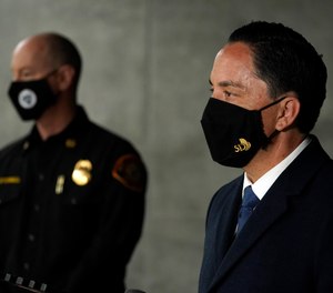 San Diego Mayor Todd Gloria, right, speaks in front of Fire Chief Colin Stowell at the scene of a deadly accident Monday, March 15, 2021. Gloria will ask the City Council to move forward with a vaccine mandate for city employees on Monday.