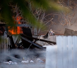 A horse stands in the back of a home where a fireworks explosion killed two people on Tuesday, in Ontario, Calif.
