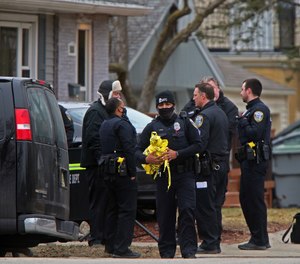 Milwaukee Police Officers and other investigators work near the intersection of North 92nd and West Townsend streets in Milwaukee, Wednesday, March 17, 2021.