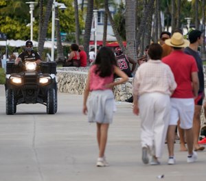 A police officer on an ATV patrols in Miami Beach, Florida's famed South Beach, Monday, March 22, 2021.