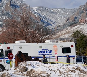 Police head into the parking lot outside a King Soopers grocery store where a mass shooting took place Tuesday, March 23, 2021, in Boulder, Colo.