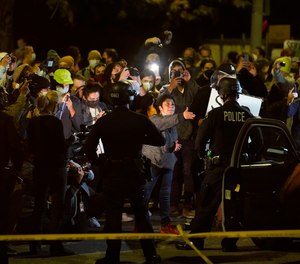 Police march toward demonstrators in the Echo Park section of Los Angeles Thursday, March 25, 2021.