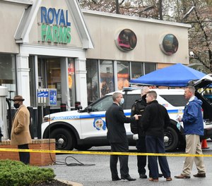 Baltimore County police investigate a shooting Sunday, March 28, 2021 at the Royal Farms in Essex, Md.