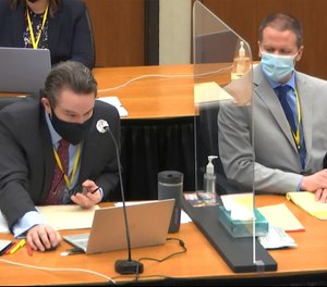 In this image from video, defense attorney Eric Nelson, left, and defendant, former Minneapolis police Officer Derek Chauvin, right, listen as Hennepin County Judge Peter Cahill presides in the trial of Chauvin, Tuesday, April 6, 2021, at the Hennepin County Courthouse in Minneapolis.
