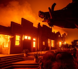 This photo shows flames from the Kincade Fire consuming a building in Healdsburg, Calif. in 2019. Pacific Gas & Electric now faces 33 criminal charges in relation to the wildfire that injured six firefighters.