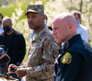 Brig. Gen. Michael J. Talley, commander of U.S. Army Medical Research and Development Command Fort Detrick, Md., left, joined by Frederick Maryland Police Chief Jason Lando, right, speaks during a news conference near the scene of a shooting at a business park in Frederick, Md., Tuesday, April 6, 2021.