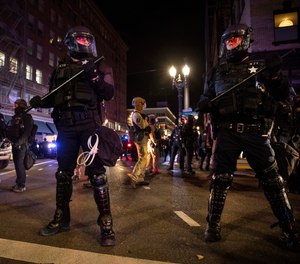 In this Nov. 4, 2020, file photo, police form a perimeter during protests following the Nov. 3 presidential election in Portland, Ore.