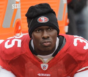 In this Oct. 17, 2010 file photo, San Francisco 49ers cornerback Phillip Adams (35) sits on the sideline during the first quarter of an NFL football game in San Francisco.