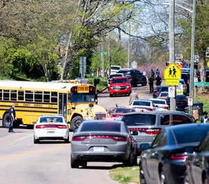 Police work in the area of Austin-East Magnet High School after a reported shooting Monday, April 12, 2021. Authorities say multiple people including a police officer have been shot at the school. (Brianna Paciorka/Knoxville News Sentinel via AP)