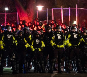 Authorities advance on demonstrators gathered outside the Brooklyn Center Police Department to protest the shooting death of Daunte Wright, late Tuesday, April 13, 2021, in Brooklyn Center, Minn.