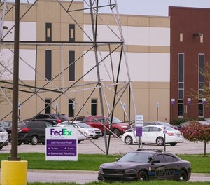 A sheriff's car blocks the entrance to the FedEx facility in Indianapolis, Saturday, April 17, 2021 where eight people were killed during a shooting late Thursday.