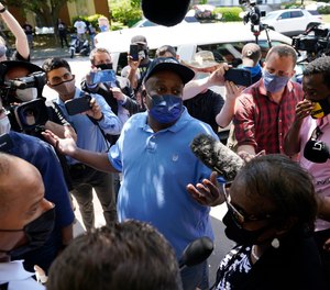 Elijah Dillard, center, is surrounded by media as he makes comments after a judges decision on the release body cam video of the shooting of Andrew Brown Jr. in Elizabeth City, N.C., Wednesday, April 28, 2021.