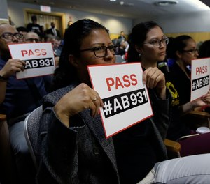 In this June 19, 2018 file photo, Rosa Cabrera, foreground, joined others in support of a measure to limit police use of deadly force, during a hearing of the Senate Public Safety Committee in Sacramento, Calif.