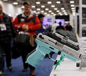 In this May 4, 2018, file photo, handguns are on display at the The National Rifle Association convention in Dallas.