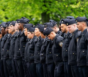 Police officers line the street as the funeral procession of New York police officer Anastasios Tsakos leaves the St. Paraskevi Greek Orthodox Shrine Church, Tuesday, May 4, 2021, in Greenlawn, N.Y.