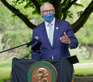 Washington Gov. Jay Inslee speaks before signing a bill into law in Tukwila, Wash., Tuesday, May 4, 2021, that levies a new capital gains tax on high profit stocks, bonds and other assets for some residents of Washington state.