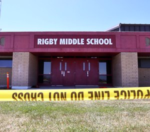 Police tape marks a line outside Rigby Middle School following a shooting there earlier Thursday, May 6, 2021, in Rigby, Idaho.