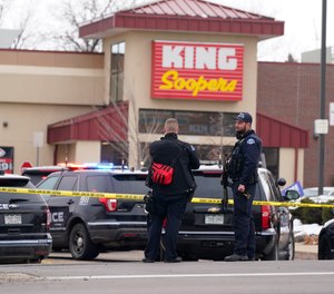 Police work on the scene outside of a King Soopers grocery store where a shooting took place Monday, March 22, 2021, in Boulder, Colo.