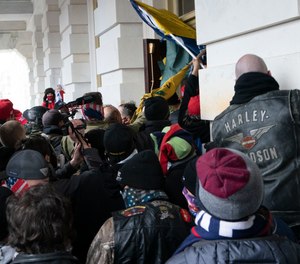 n this Jan. 6, 2021 file photo Trump supporters try to open a door of the U.S. Capitol as they riot in Washington.