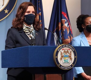 Michigan Gov. Gretchen Whitmer (left) vetoed a bill that would have allowed local government officials in more municipalities to also serve as first responders.