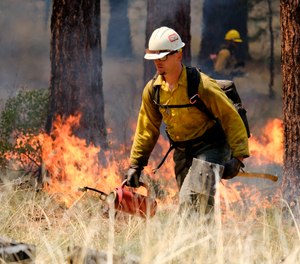 U.S. Forest Service firefighters carry out a prescribed burn on the grounds of the High Desert Museum, near Bend, Oregon. The prescribed burn is part of a massive effort in wildlands across the West to prepare for a fire season that follows the worst one on record.