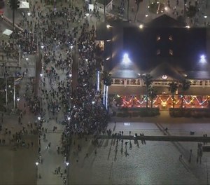 This Saturday, May 22, 2021 aerial screenshot provided by FOX 11 KTTV shows people gathered at the Huntington Beach pier in Huntington Beach, Calif.