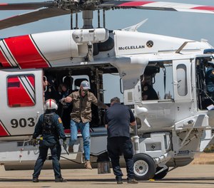California Gov. Gavin Newsom jumps out of a new Sikorsky S70i Black Hawk firefighting helicopter after arriving to highlight new firefighting equipment and his proposed $2 billion investment in wildfire and emergency preparedness at a press conference in McClellan Park in Sacramento County on Monday, May 24, 2021.