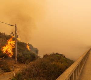In this Sept. 11, 2020 file photo firefighters with Vandenberg Air Force Base light a back burn to help control the Dolan Fire at Limekiln State Park in Big Sur, Calif.