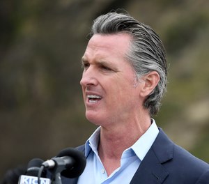 California Gov. Gavin Newsom has pardoned two inmates firefighters who were facing deportation to Laos.
