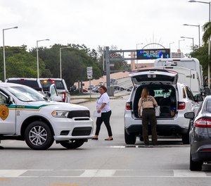 Police block an intersection near the Miami-Dade Kendall Campus in Miami, Fla., on Sunday, June 6, 2021. Three people are dead and at least six others injured following a shooting at a Florida graduation party, the latest in a string of such violence in the Miami area, police said Sunday.