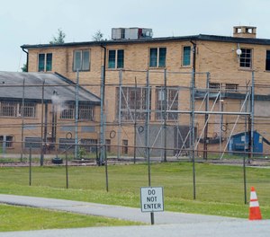 High fences surround buildings on the grounds of the Edna Mahan Correctional Facility for Women in Clinton, N.J., Tuesday, June 8, 2021.