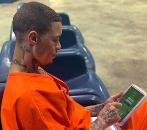 Inmate Byron Robinson works on a new Securus tablet, which are being provided for free to Oklahoma inmates as part of a new program by the Department of Corrections.