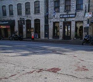 Blood stains remain in the street at the 400 block of Sixth Street in Austin, Texas, where a man shot and killed one person and injured 13 people early in the morning on Saturday, June 12, 2021.